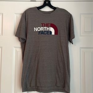 North Face Men’s Dark Gray T-Shirt with large matron, white, and blue logo